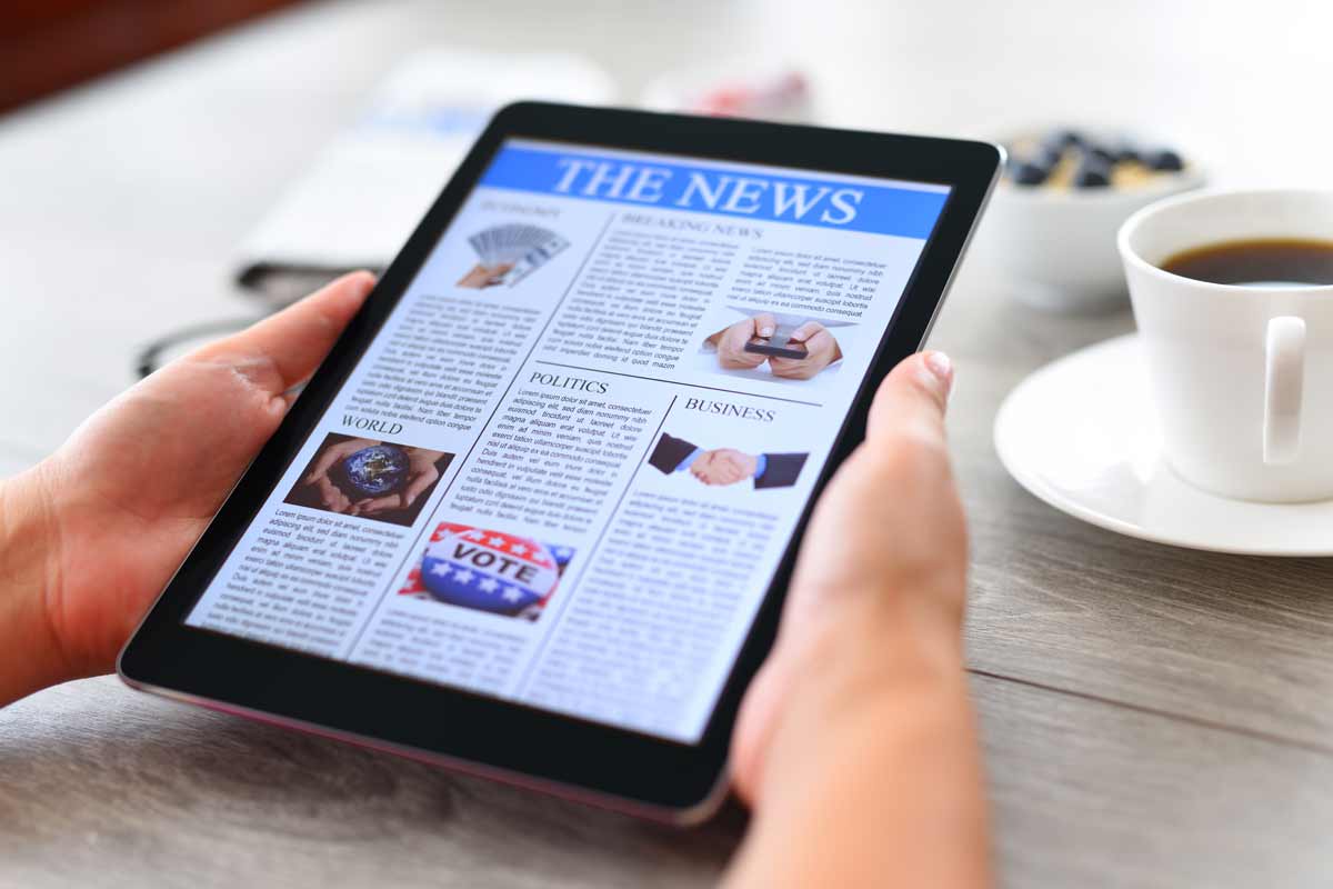 Photo of a tablet with news on the screen