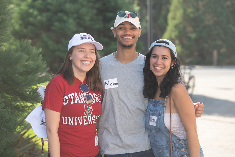 Photo of three people posing for a camera