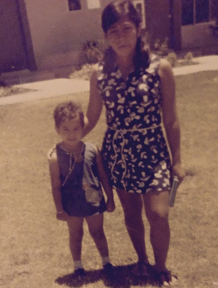 Young Haydee with young Aunt Maria holding a book.