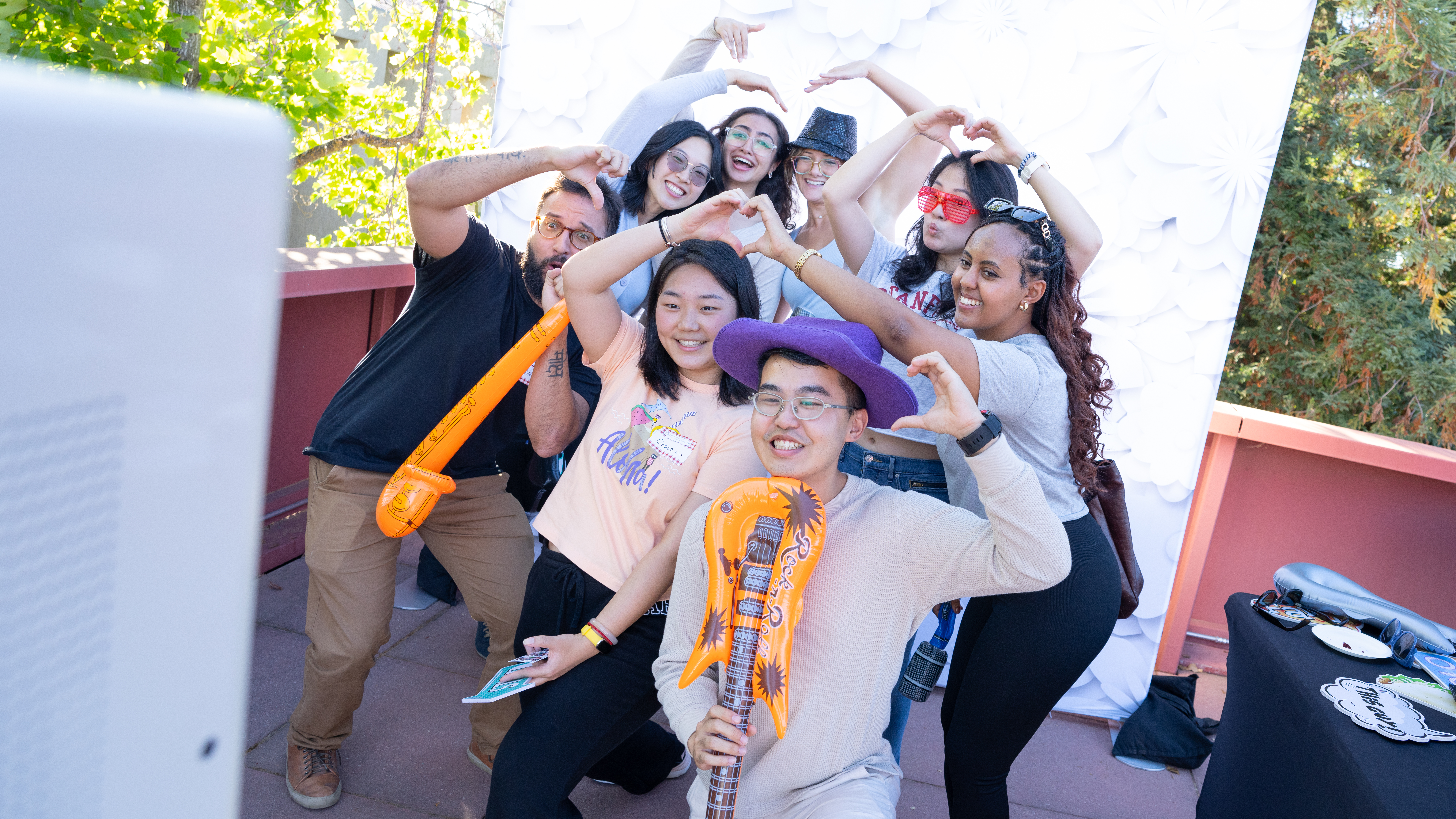 New students pose with props at the photo booth station during the dean’s fall kickoff barbecue event. 