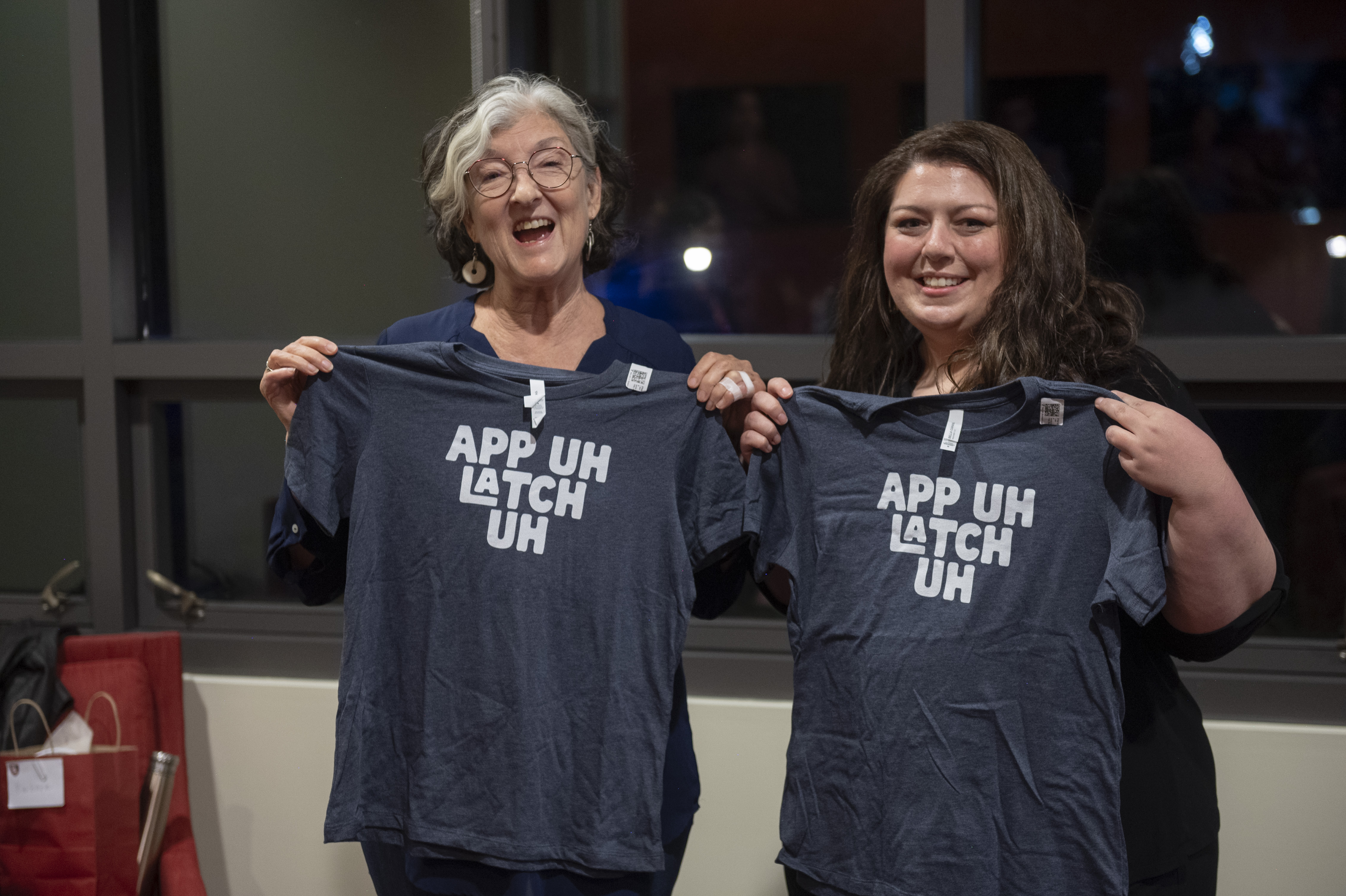 Kingsolver (left) and GSE PhD student Kelly Boles (right), hold up shirts pronouncing Appalachia. (Photo: Rod Searcey)