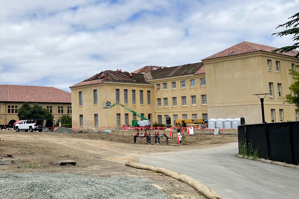 Construction site with North building roof tiles being removed 