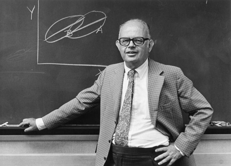 Professor Lee Cronbach standing in front of a chalkboard.