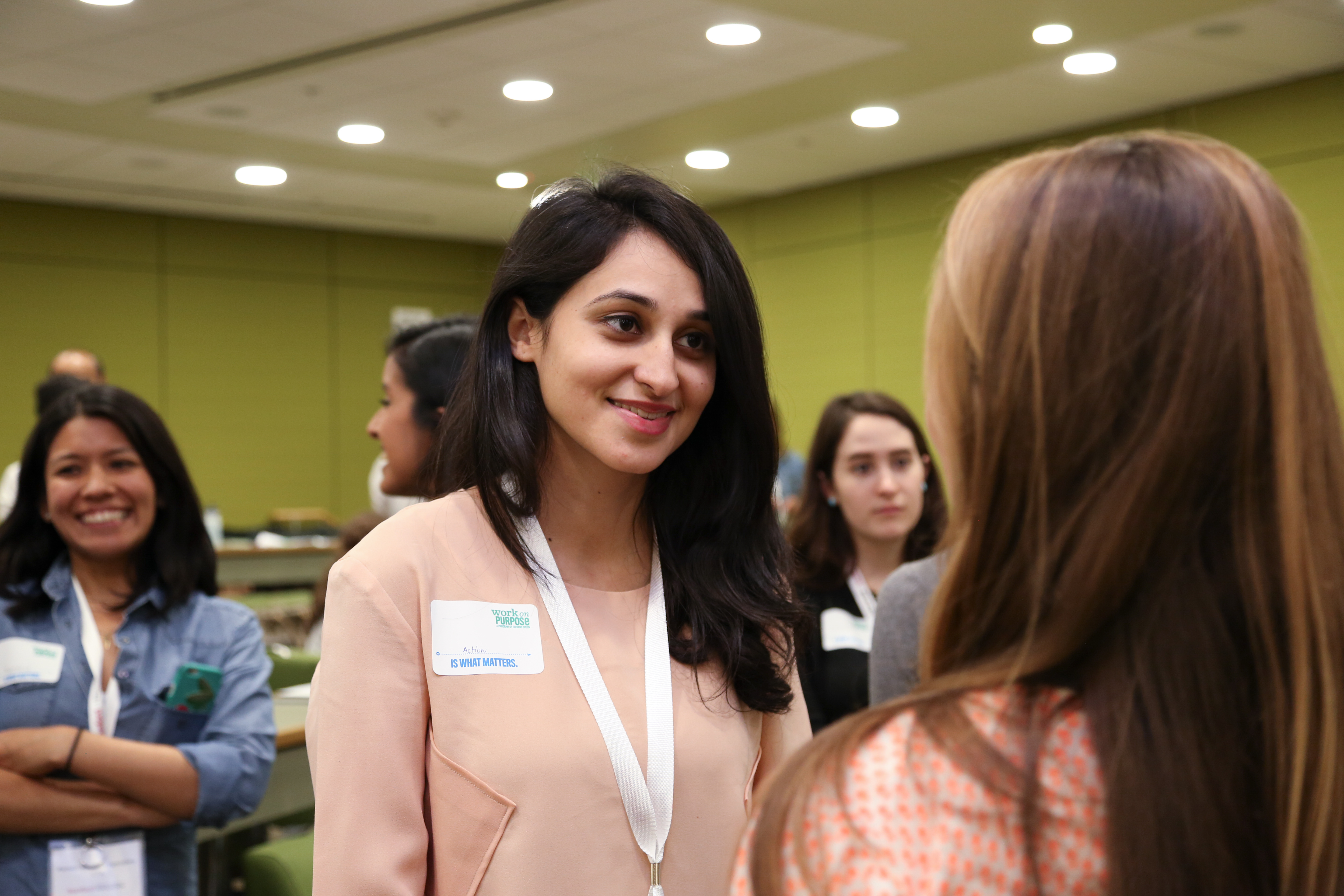 Female students with lanyards on at an event