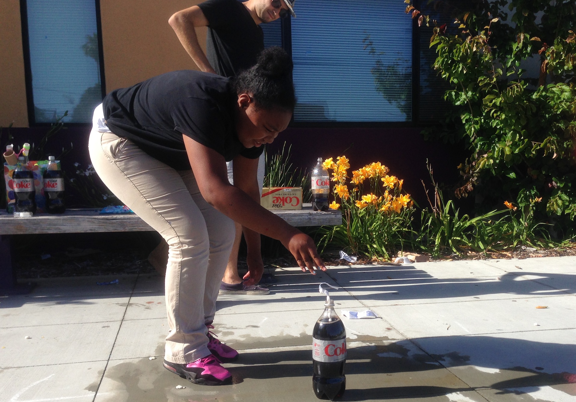 A student in the afterschool d. Loft STEM Learning program conducts a science experiment with soda (Photo by Tanner Vea)