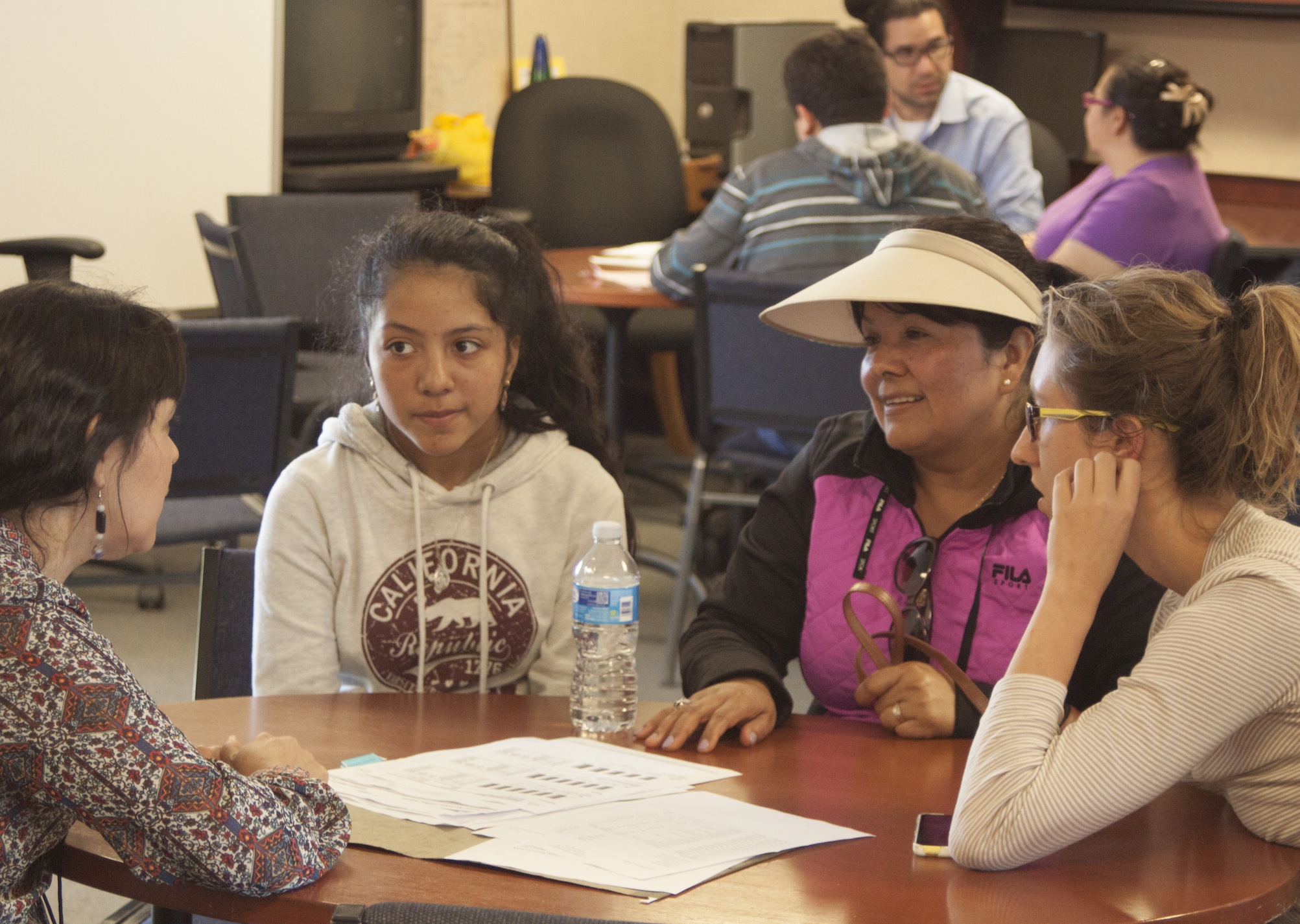GSE student Maddie Orenstein, right, interprets during a parent-teacher conference at Pescadero Middle School.