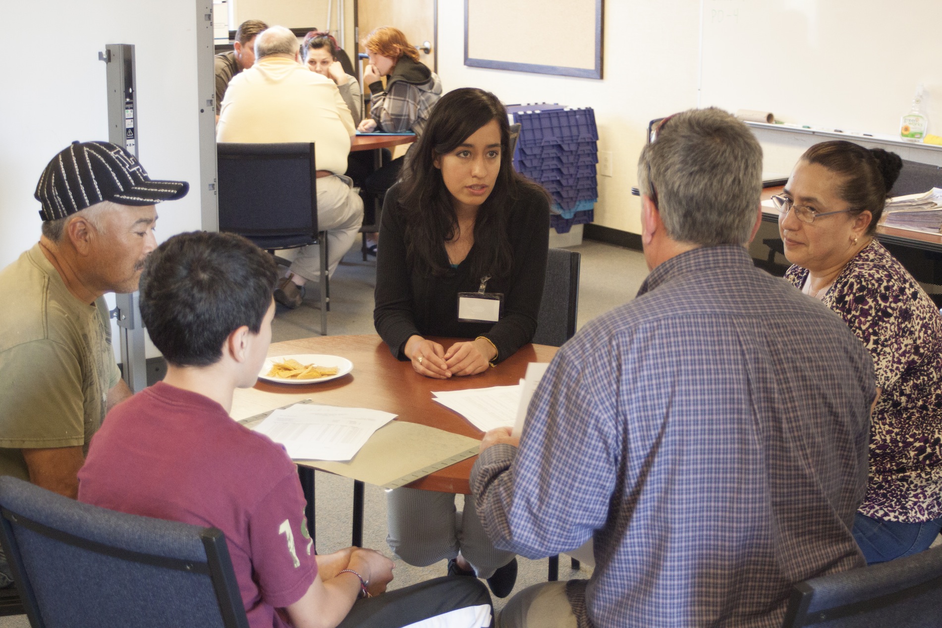 GSE student Jessica Barajas, center, interprets during a parent-teacher conference at Pescadero Middle School.