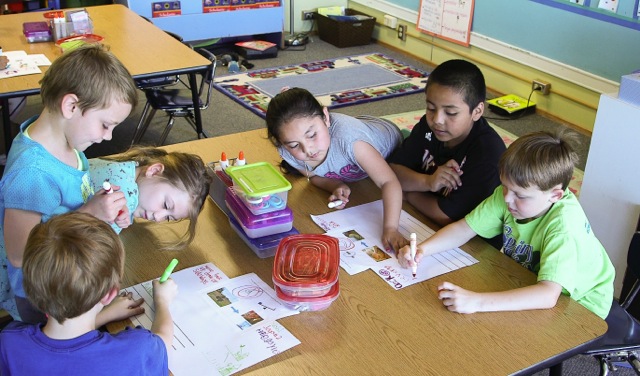 First graders in a dual language program in Corvallis, Ore. work on a poster project.