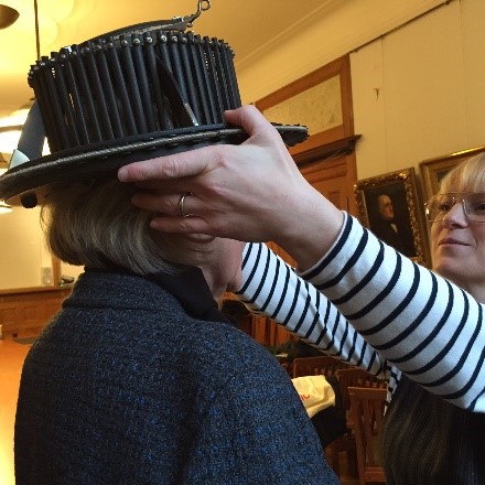 Milbrey McLaughlin is fitted with a hat, part of the insignia given to those awarded honorary doctorates. (Photo courtesy of Milbrey McLaughlin)
