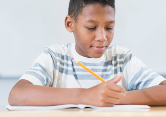 Photo of African American boy doing a writing exercise