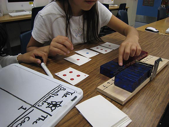 As part of a four-hour curriculum on integers, fourth-grade students played games using a special number line that could be folded in half at the zero point, allowing the symmetry between positive and negative quantities to stand out. (Courtesy of Stanford AAA Lab)