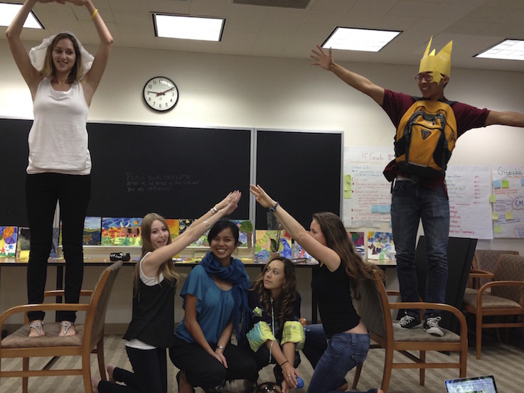 Group of students acting out a castle and royalty