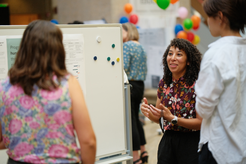 Photo of EDS student presenting her project in front of two people