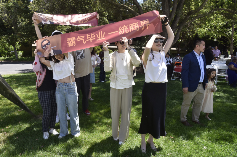 GSE family members cheered on their graduates with banners, flags, flowers, and signs. (Photo: Charles Russo)