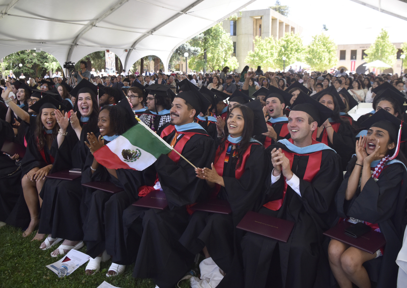 Stanford Teacher Education Program (STEP) students cheer on other graduates receiving their diplomas. (Photo: Charles Russo)