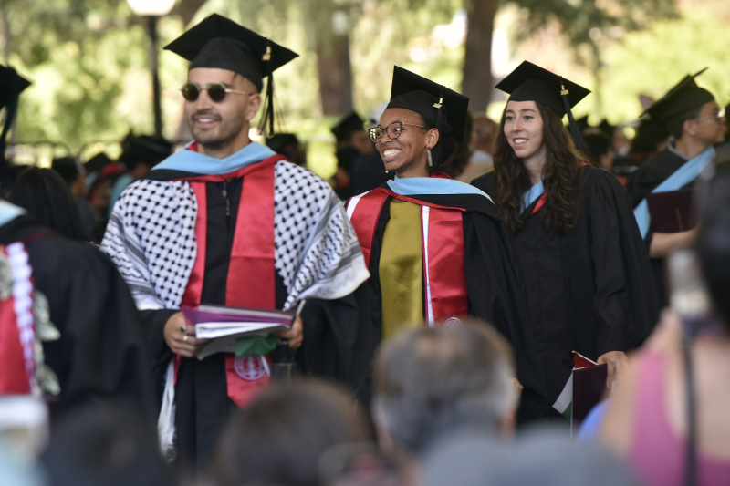 Education Data Science master’s graduates beam during the commencement recessional. (Photo: Charles Russo)