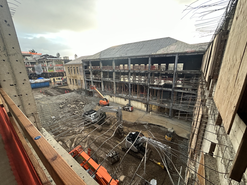 A view of the future site of the north building atrium and auditorium, as seen from the third floor, with the new south building in the background, January 2024