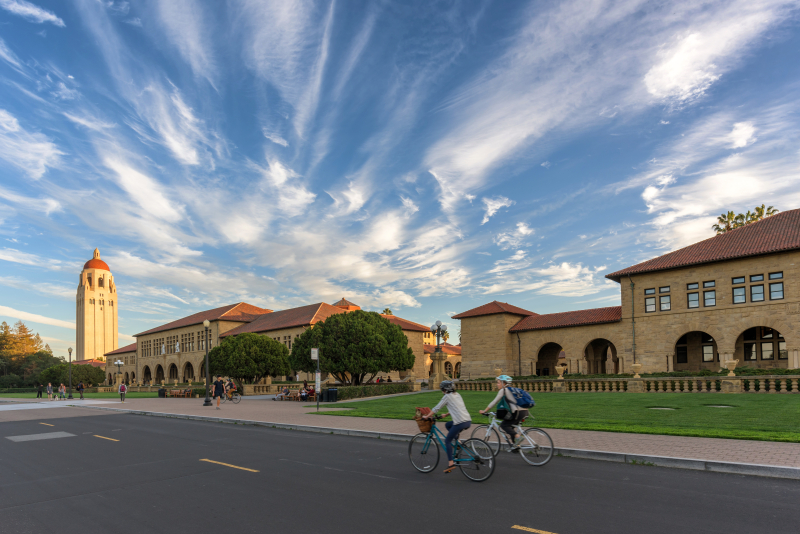 Students biking in front of Stanford Quad