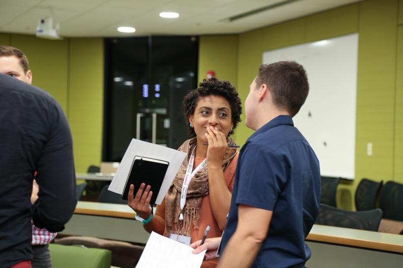 Photo of two students talking in a hall