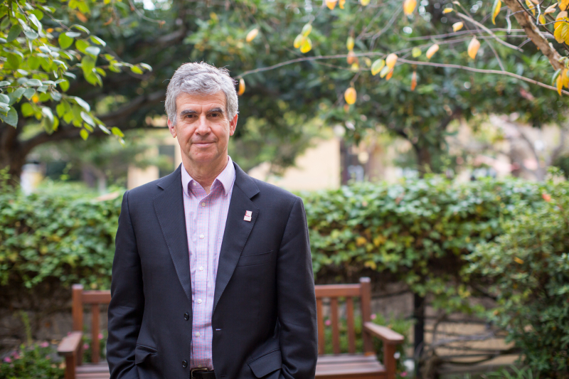 Portrait of GSE Dean Dan Schwartz standing in a garden by Holly Hernandez