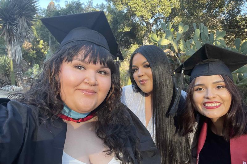 Photo of three STEP students in graduation caps and gowns