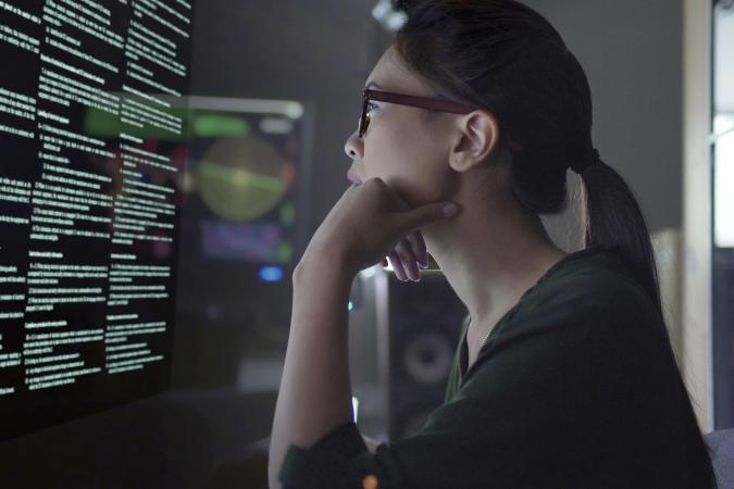 Photo of student examining data on a screen