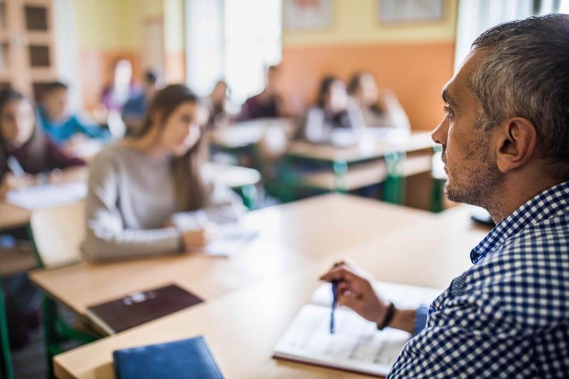 Photo of teacher in front of a classroom