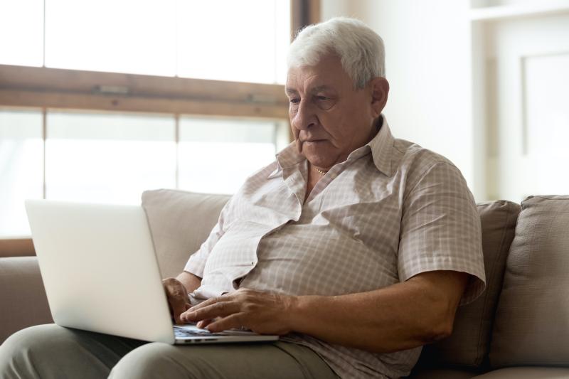 Photo of older man on a computer