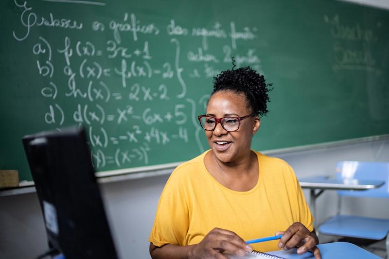 Photo of a teacher teaching online from a classroom