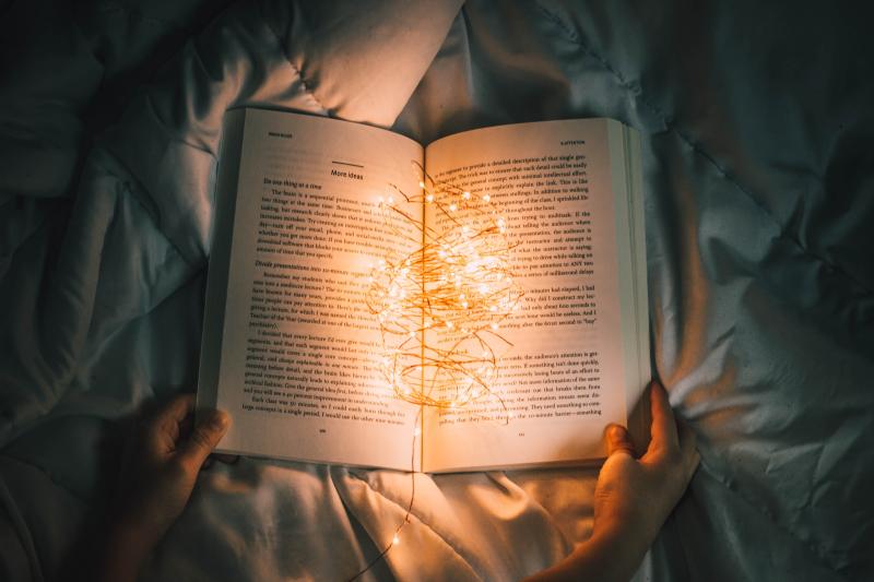 Photo of an open book with a string of lights