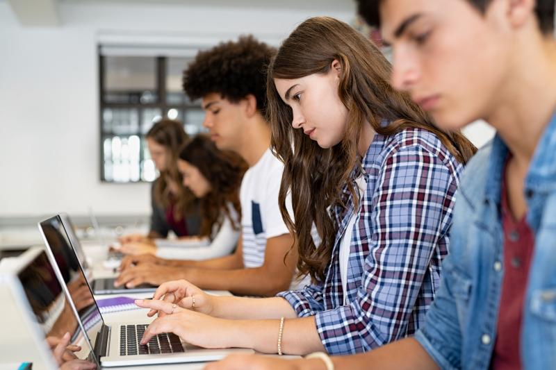 Students typing on laptops