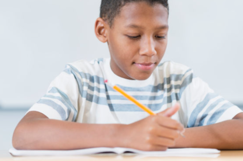 Photo of African American boy doing a writing exercise