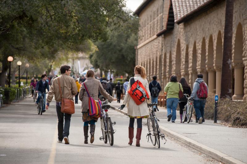 Photo of students riding and walking their bikes.