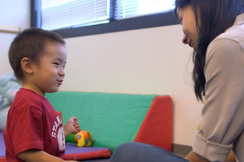 Female teacher speaking to a child