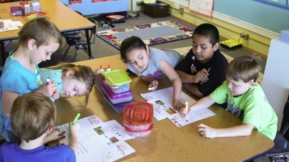 First graders in a dual language program in Corvallis, Ore. work on a poster project.