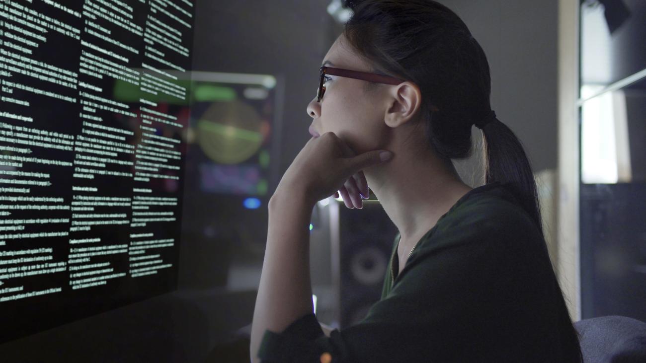 Photo of student examining data on a screen