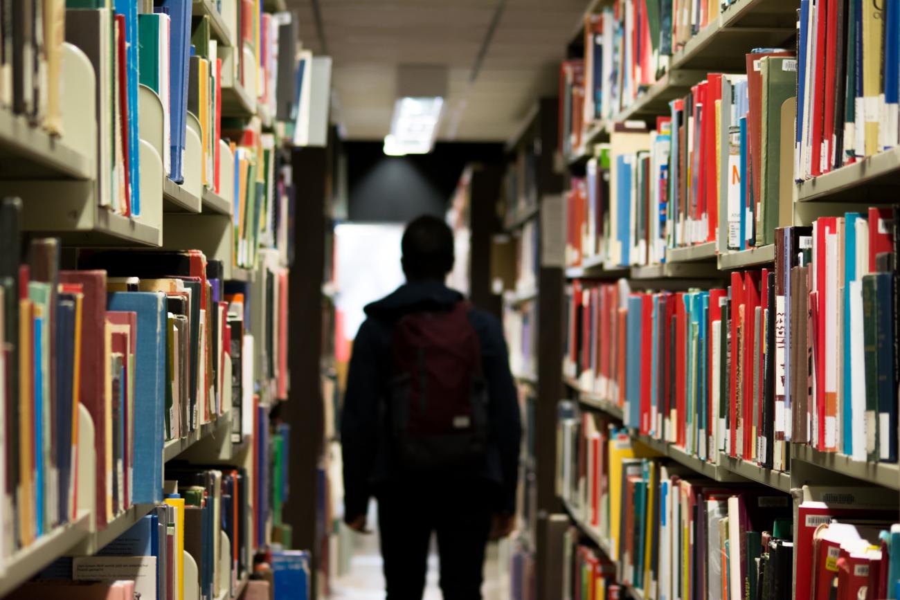 Photo of shadow of a teenager in a school library