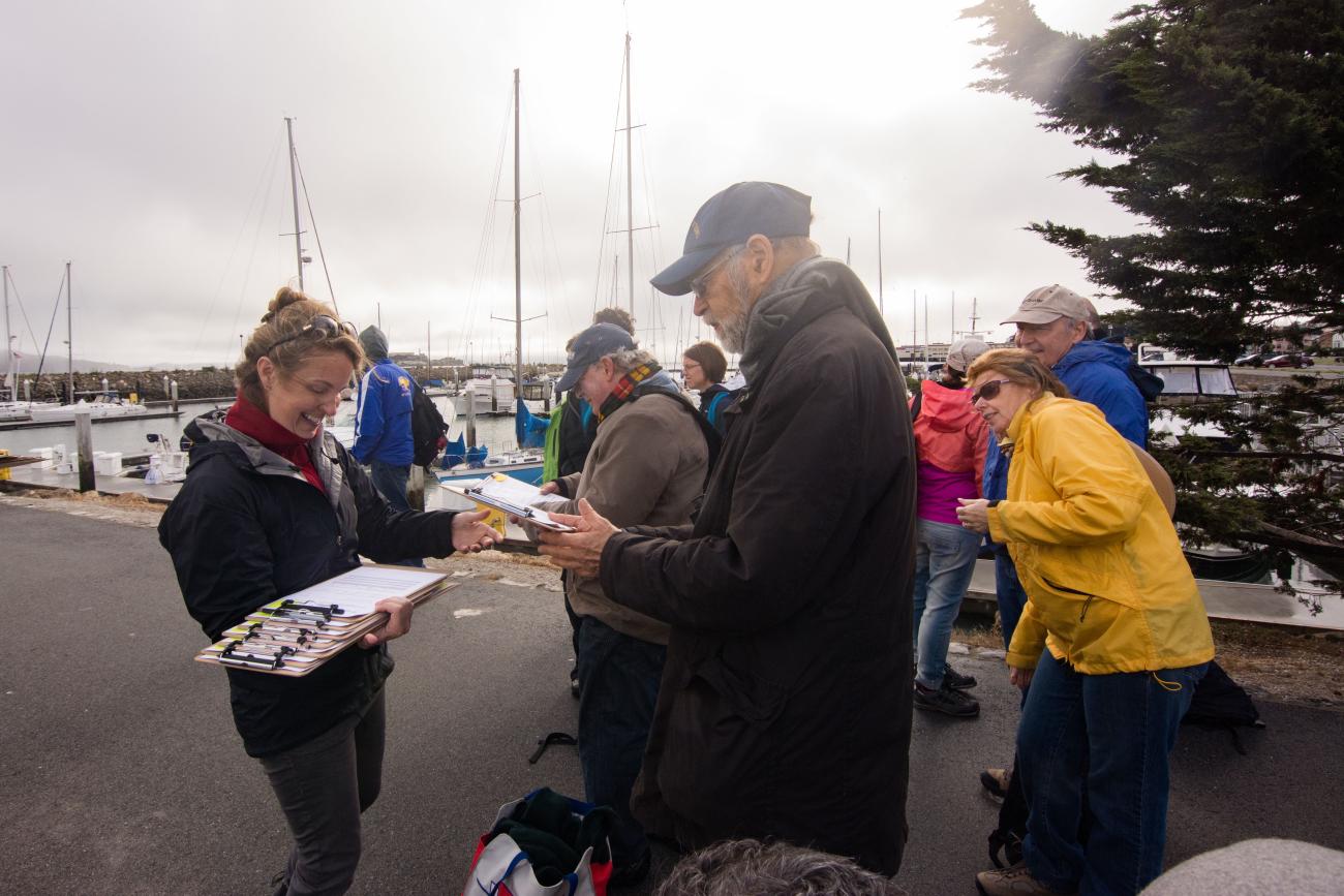 Photo of Nicole Ardoin distributing surveys