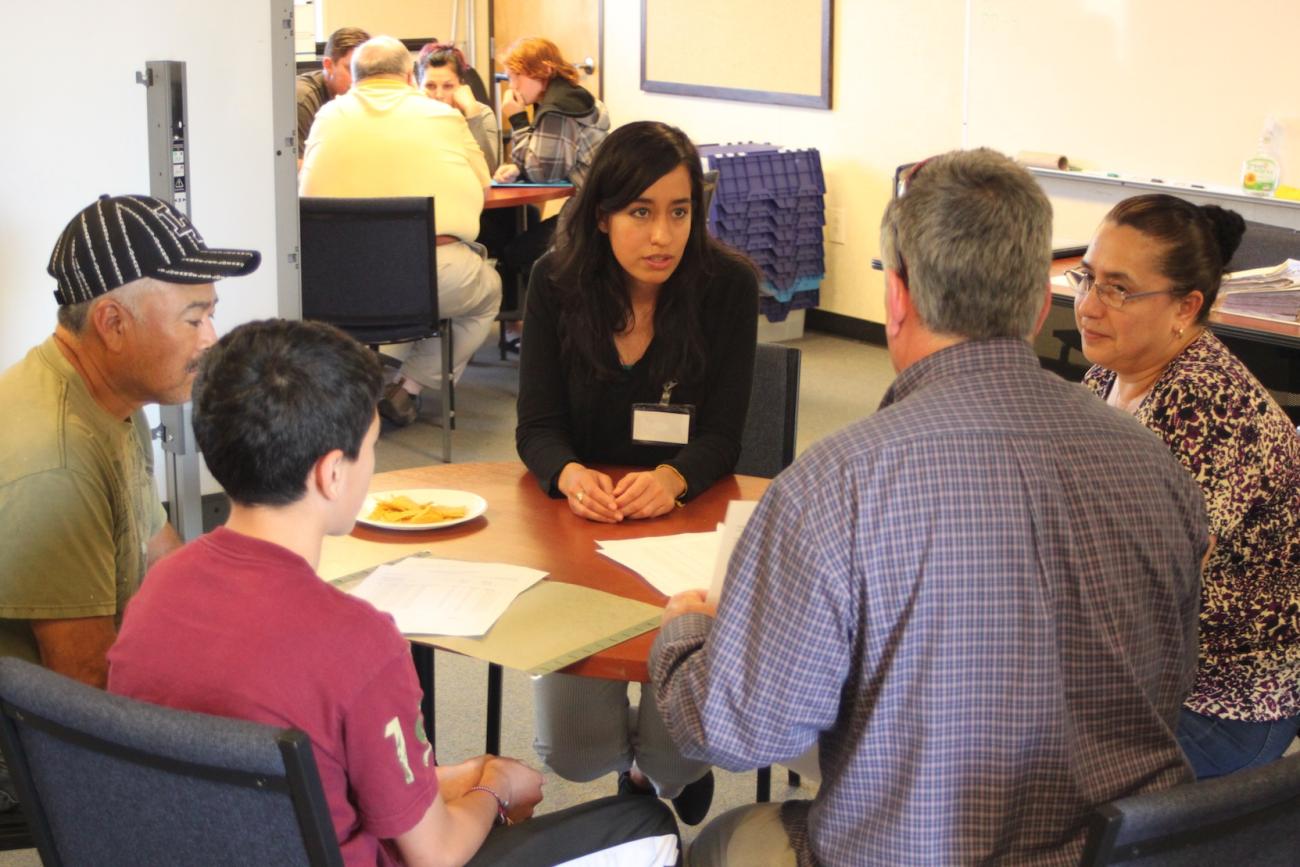 Group of attendees talking around a table.