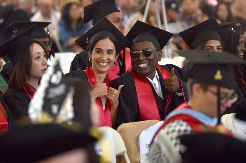 GSE 2024 graduates pose for pictures in the crowd at commencement. (Photo: Charles Russo)