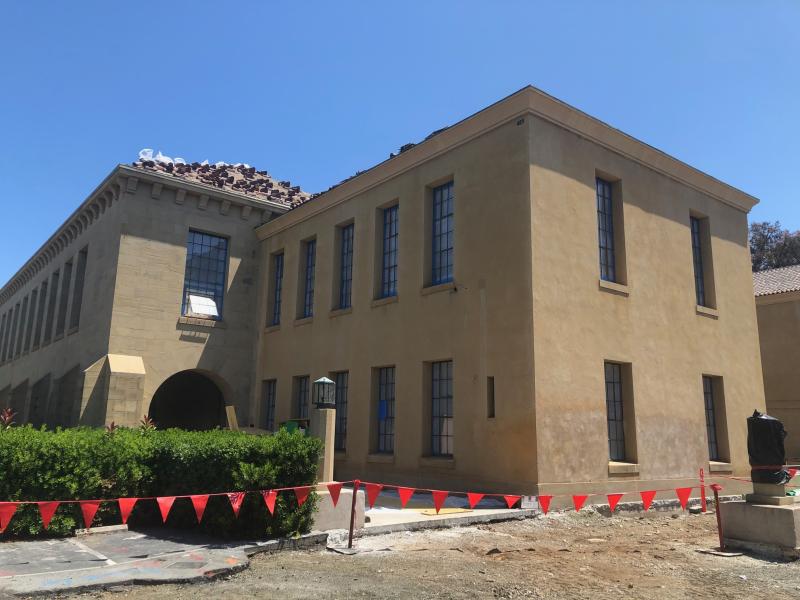 At the start of construction, the iconic red roof tiles of the north building were removed and stored. They’ll be reinstalled later in the project. (Photo courtesy McCarthy Construction)