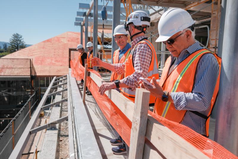 Professor Ira Lit chats with senior project manager Mike Mithen as faculty members take in the view from the fourth floor of the new south building. May 9, 2024 (Photo: Ryan Zhang)