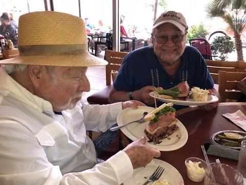 Lee Shulman (left) and David Berliner eat pastrami sandwiches together at a delicatessen, one of many favorite pastimes they shared. (Photo courtesy: David Berliner)