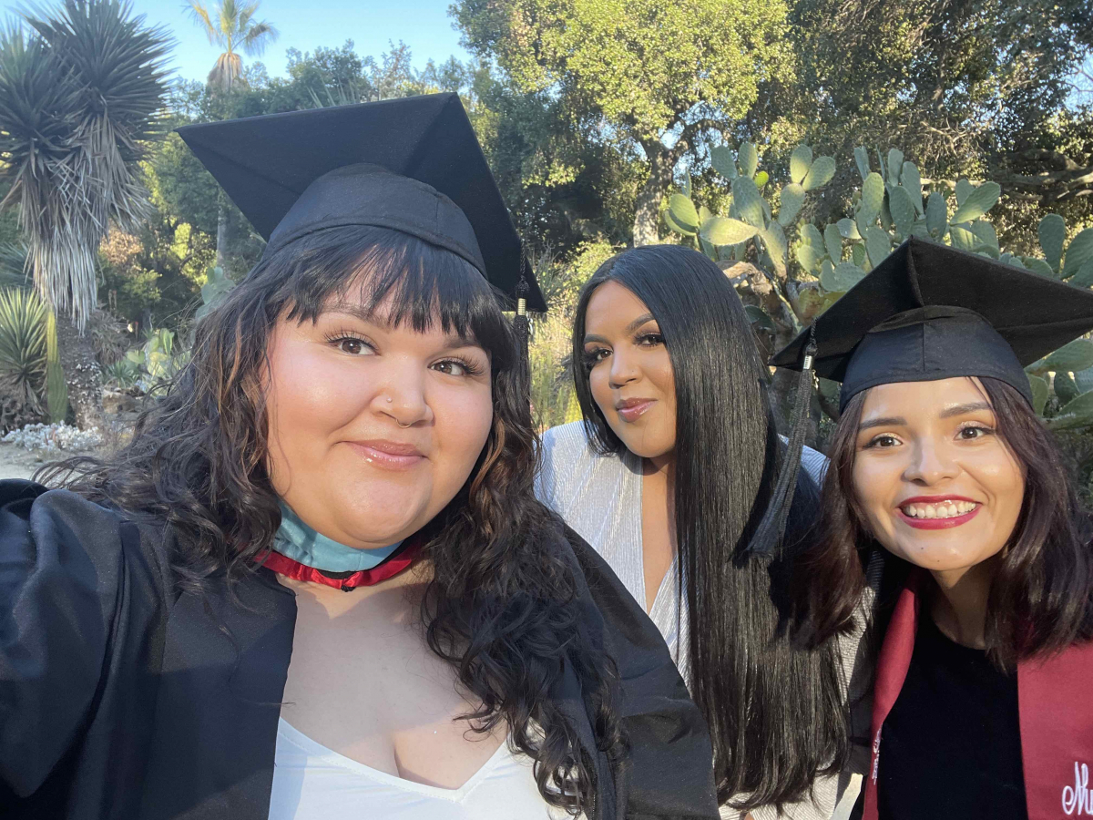 Photo of three STEP students in graduation caps and gowns