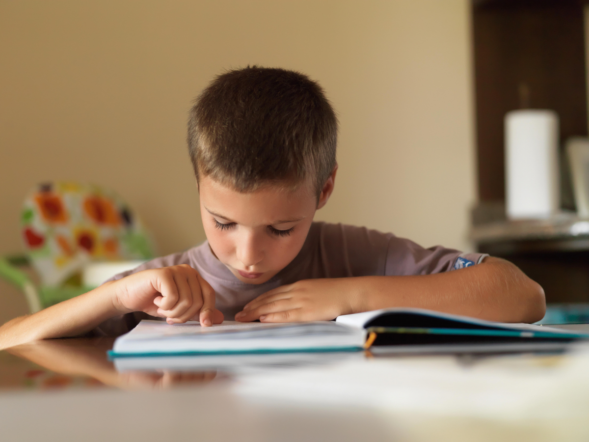 Photo of young boy reading