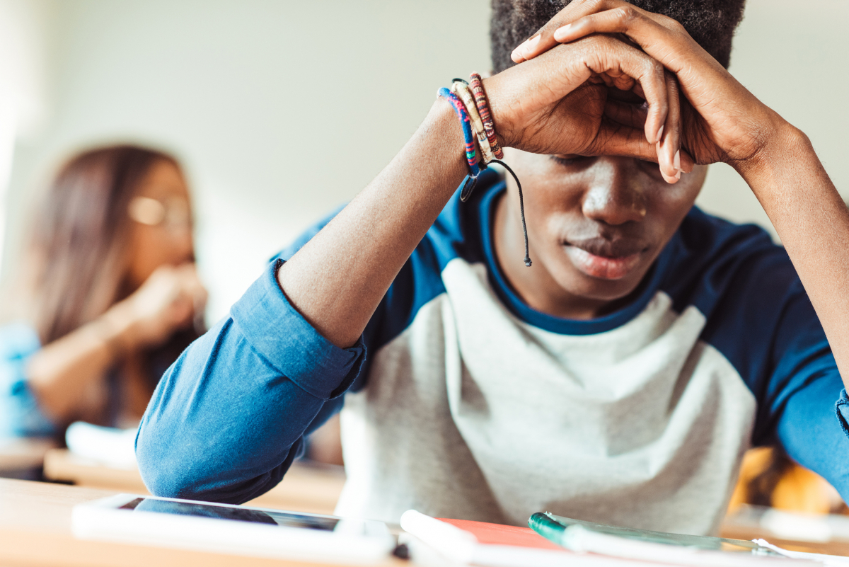 Student in concentration at his desk.