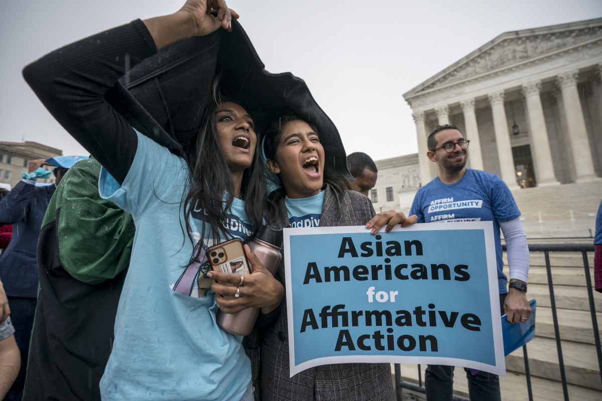 Photo of students in front of Supreme Court with sign saying "Asian Americans for Affirmative Action"