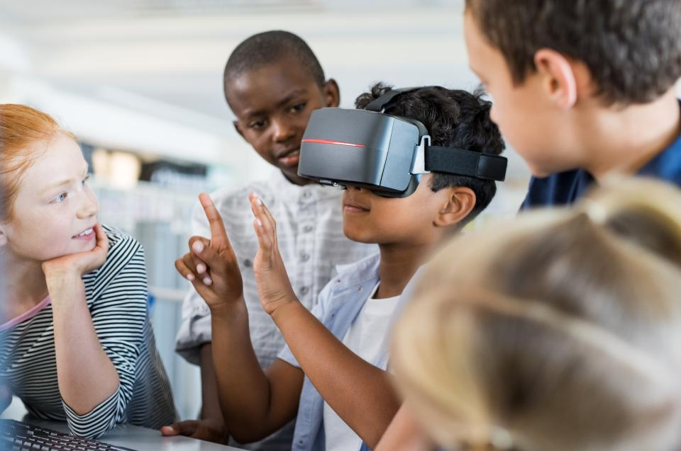 Photo of students using virtual reality headset in the classroom