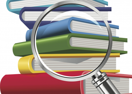 Magnifying glass on a stack of textbooks