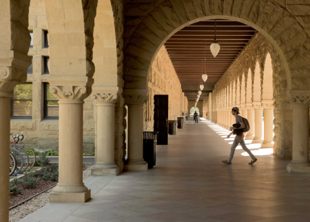 Student crossing a path on a university campus